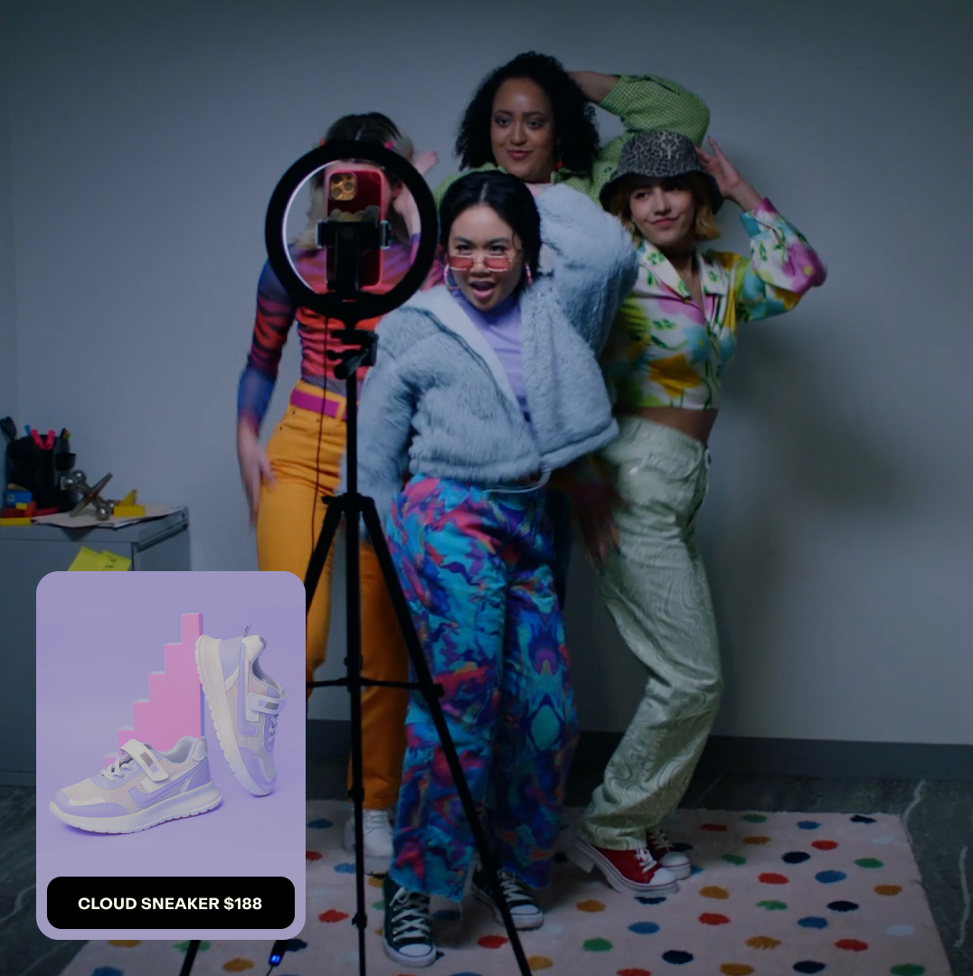 A group of four content creators who are recording a marketing video on a mobile device