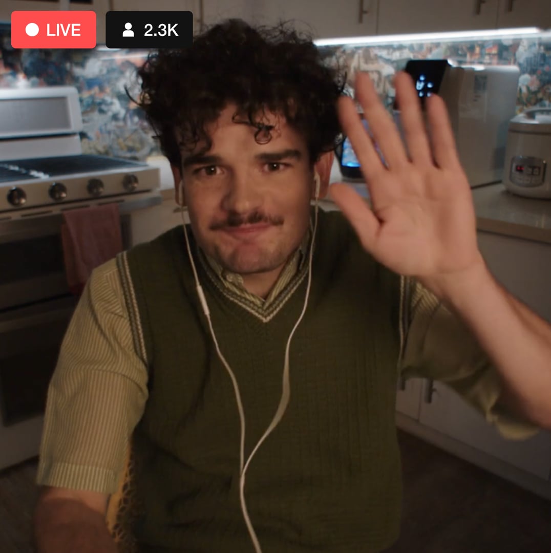 Man waving in a live streaming video with thousands of live event viewers