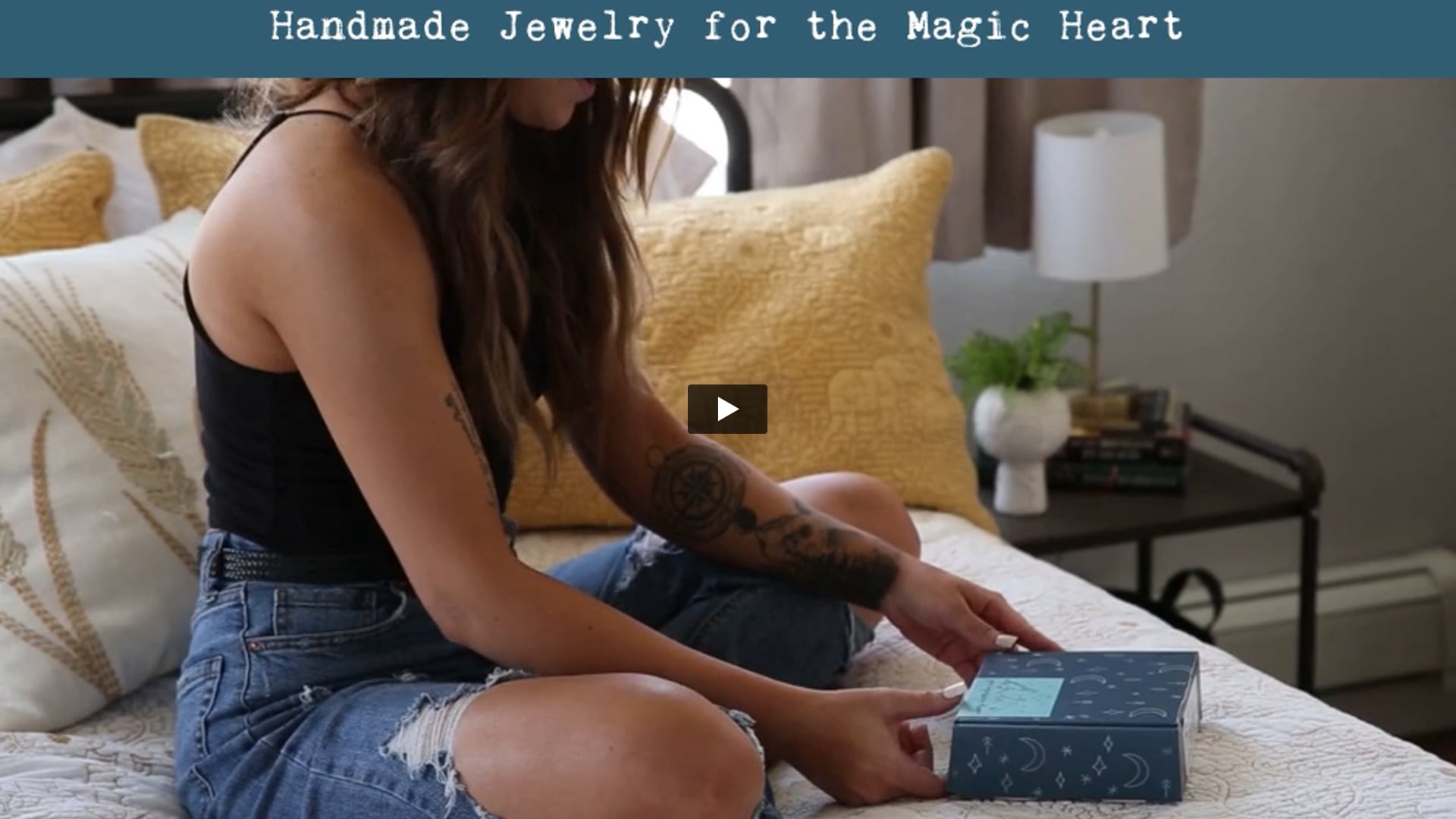 Video of woman opening up a jewelry subscription box.