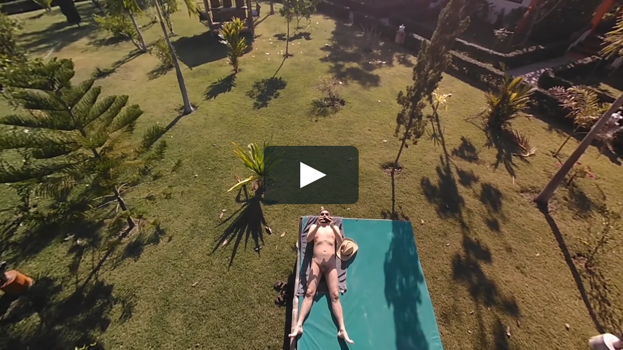 Nude sunbathing departure angle drone shot.