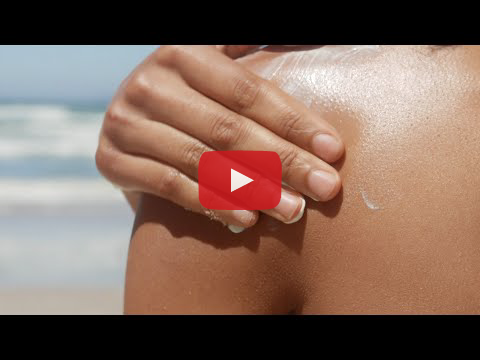 An image of a hand applying sunscreen to the shoulder with a "play" button to indicate a video.