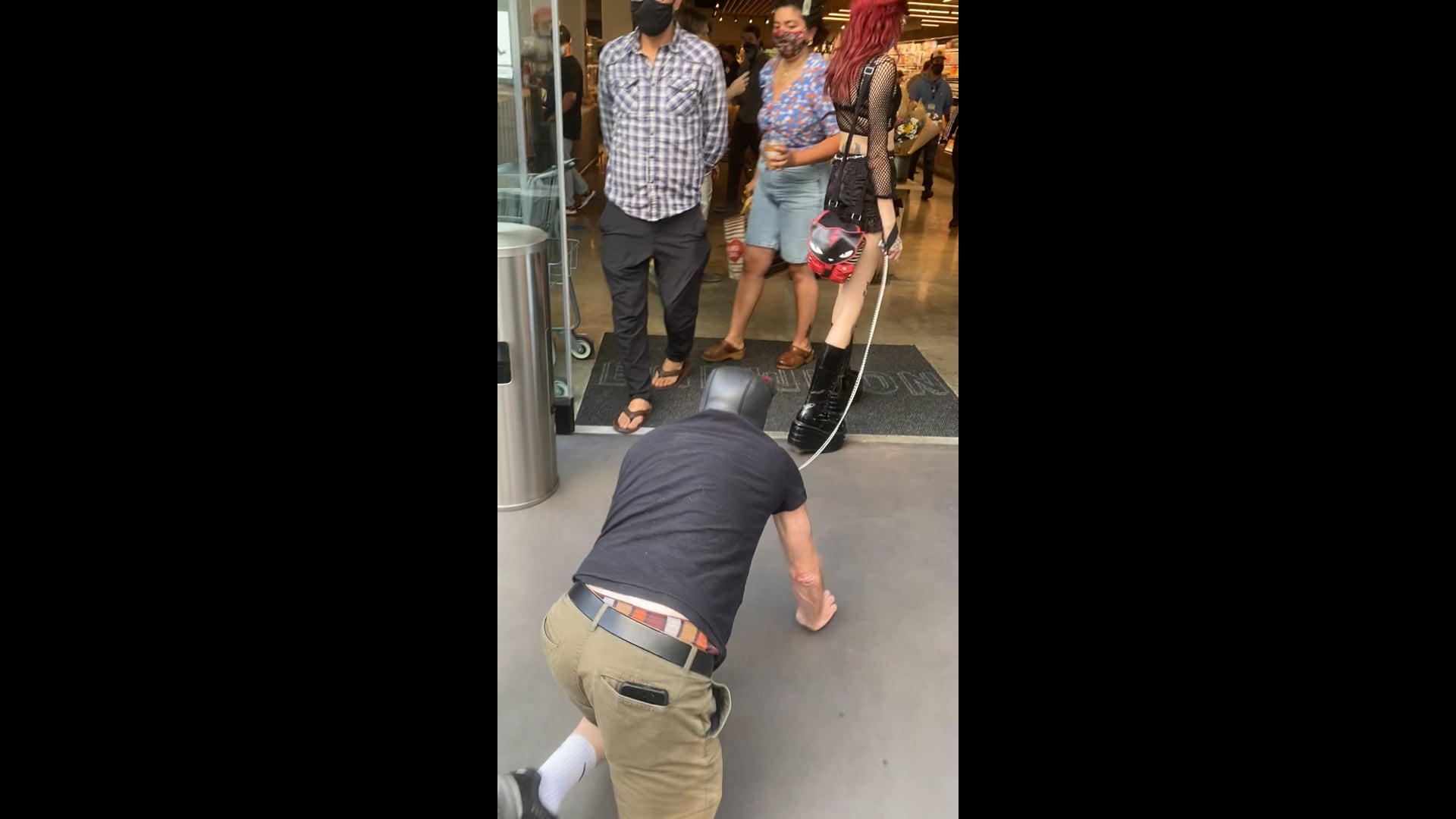 Mistress Lark walks human dog on leash through supermarket