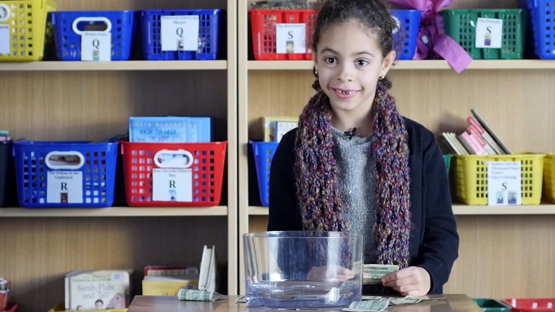 Children look for a woman on the $20