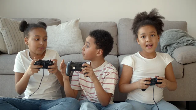 Children playing video game - Stock Photo - Masterfile - Premium