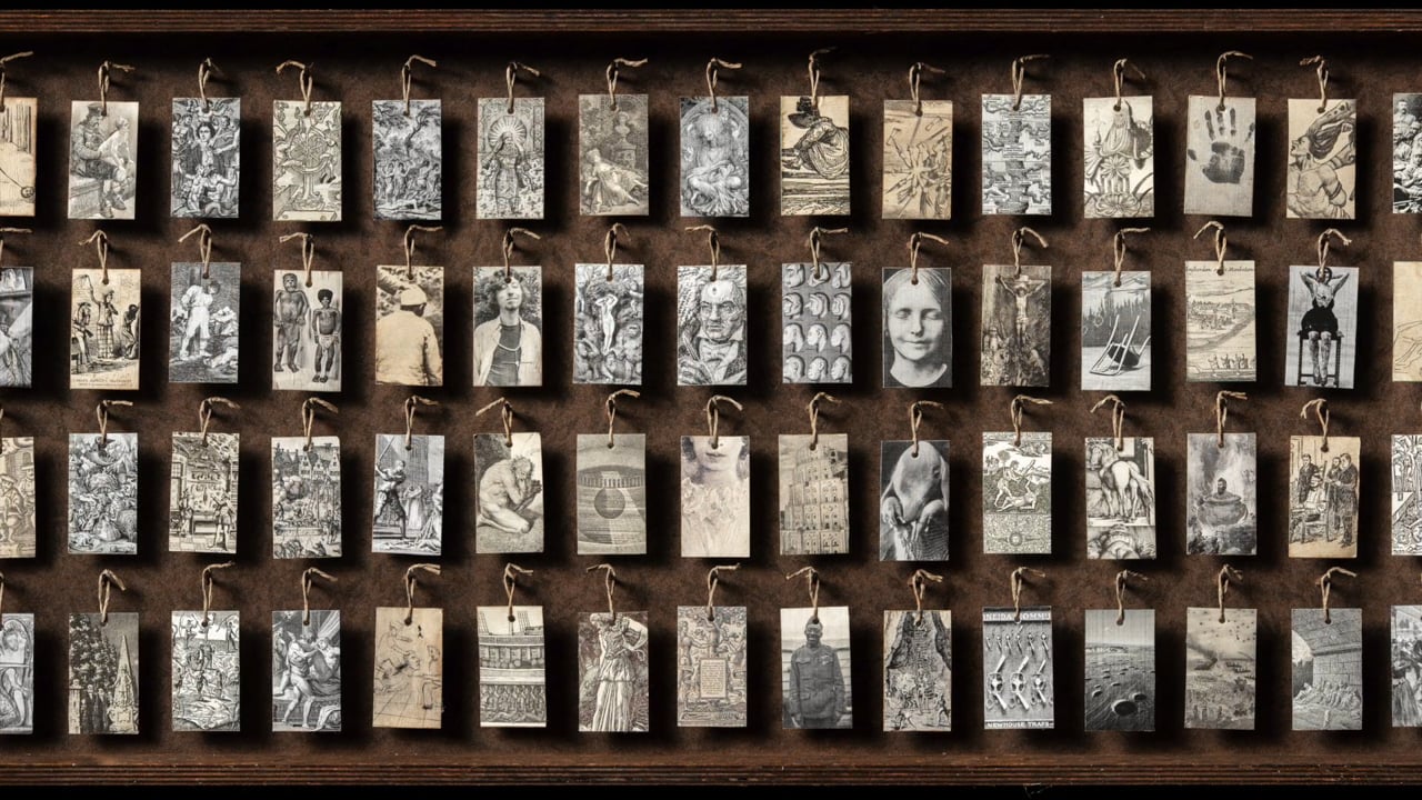 Tags with art and historical imagery applied, hanging from pegs in shallow  boxes. - Allen Schill - Still Life Photography