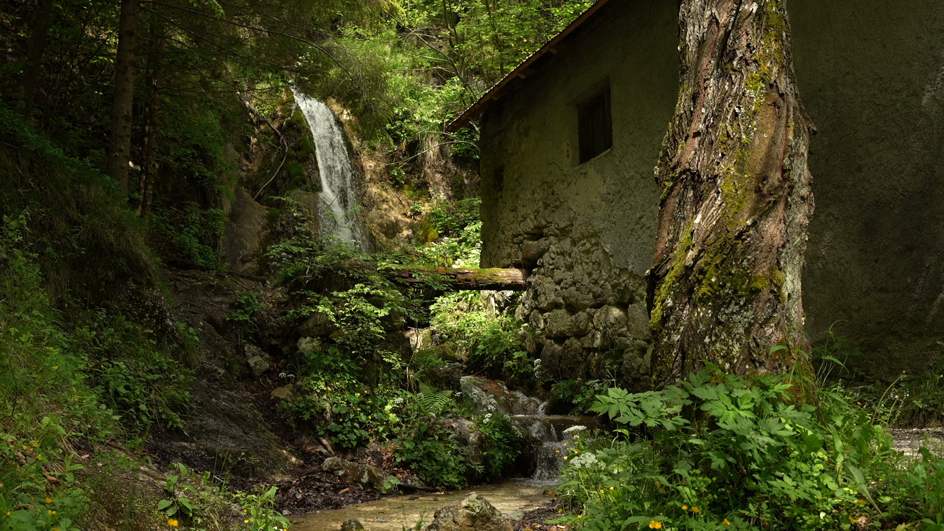 Waterfall near old stone house