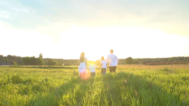 Family Running Through Field