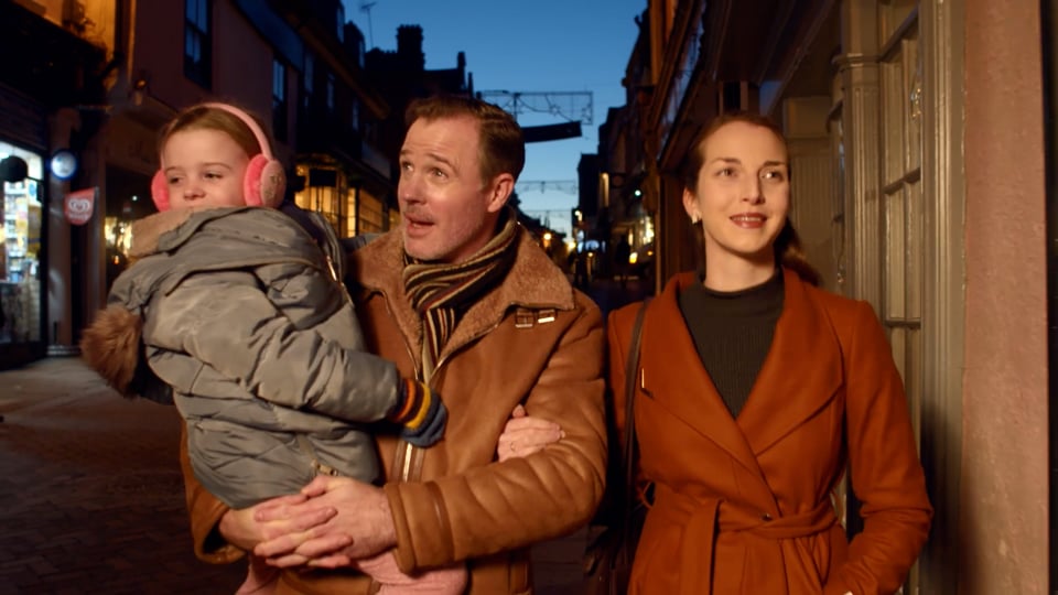 A family walking down a High Street in Bury St Edmunds