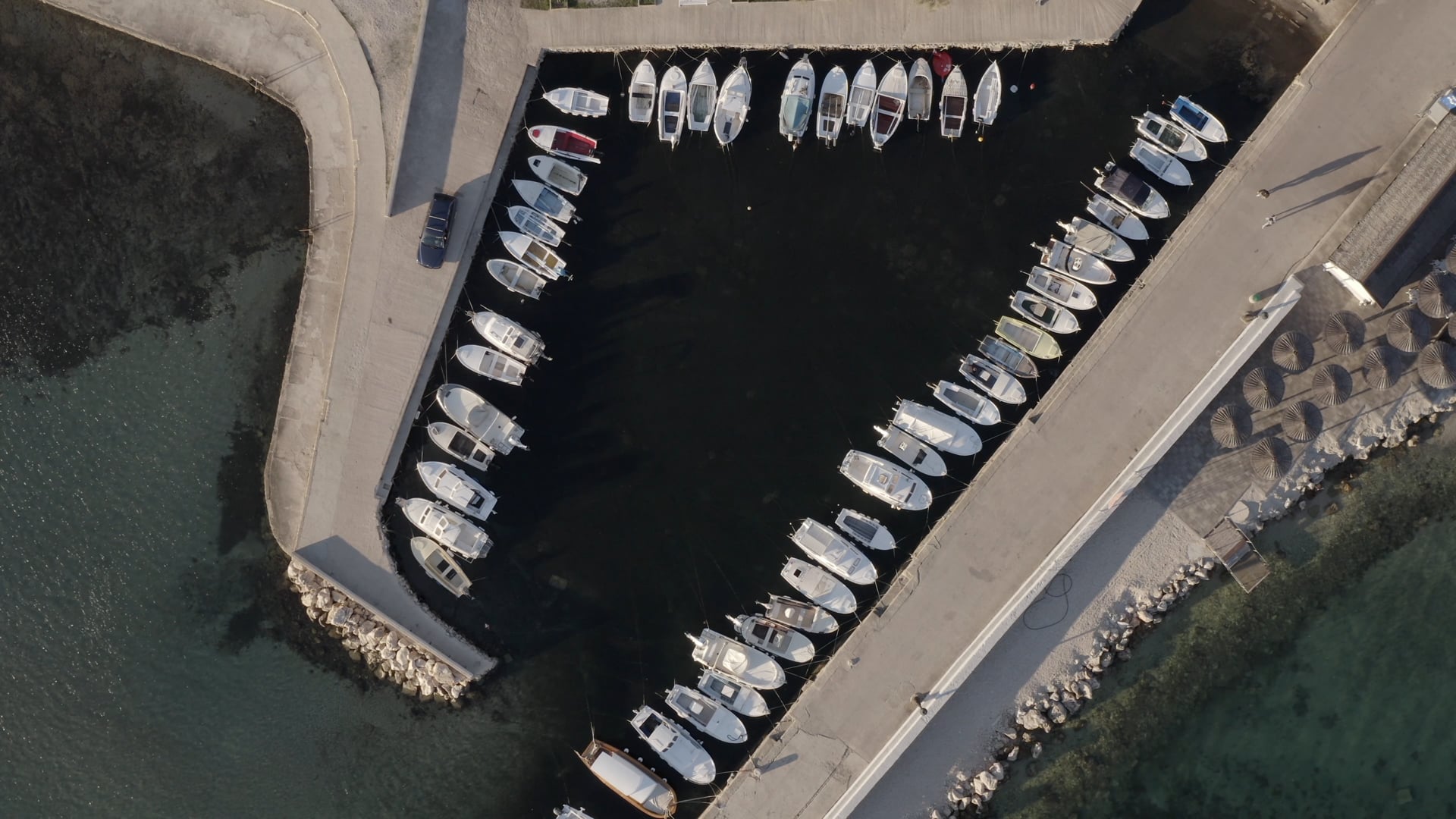 Car drive small pier on the island of Vir