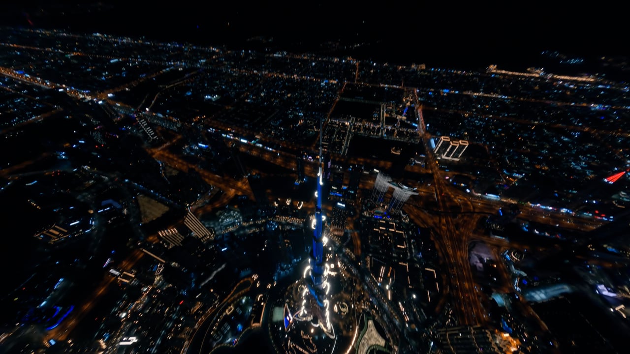 Wide drone view of the Downtown Dubai skyline at night