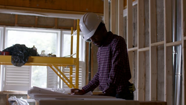 A contractor works on the plans for his clients dream home. 