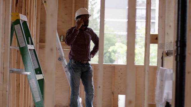 An architect talking to his foreman about a home renovation. 