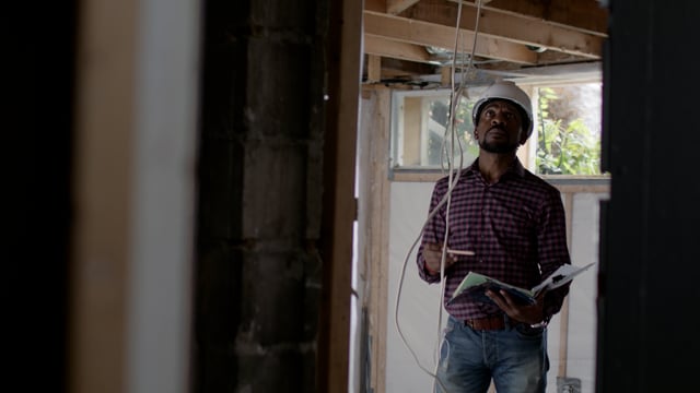 An African American contractor working on a home repair. 