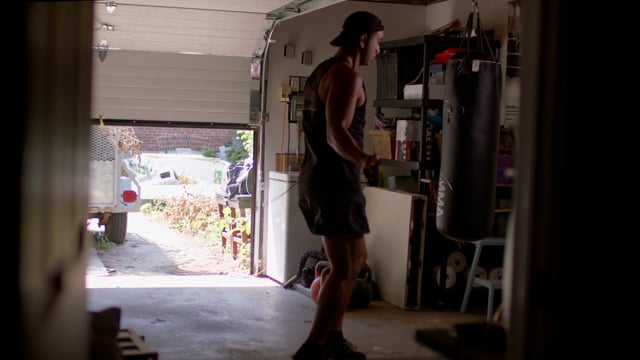 Tough Asian Millennial jumps rope training for his next big fight in his home gym.