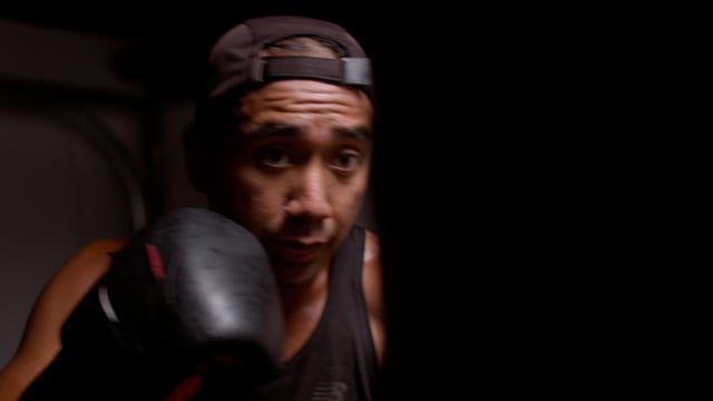 A Boxer hits the pads hard during an intense workout