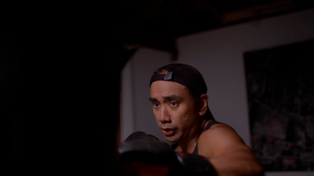 Muay Thai Boxer hits the pads hard.