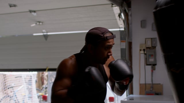 Boxer takes a breather after a boxing session.