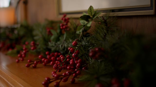 Holiday garland decorations strung along a family room mantle for the Christmas Season. 