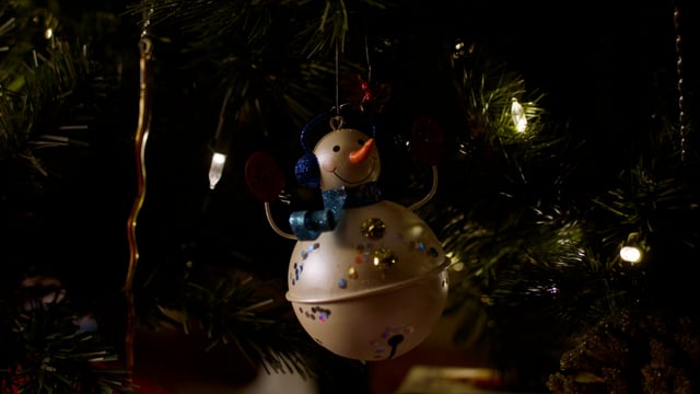 Snowman holiday ornament. Christmas celebration and cheer. Presents decorations and holiday joy. 