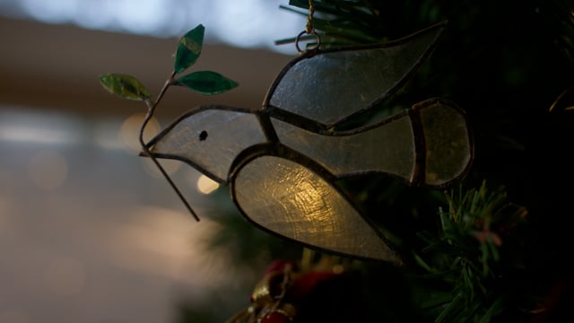 Dove Christmas ornaments hanging on Christmas tree.  