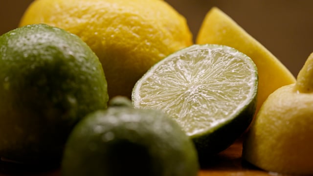Lemons and limes, organic and freshly cut, being misted to stay fresh. 