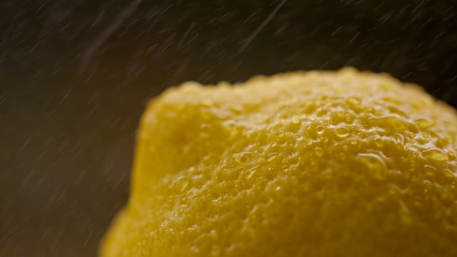 Macro shot of a juicy oraganic lemon being sprayed.