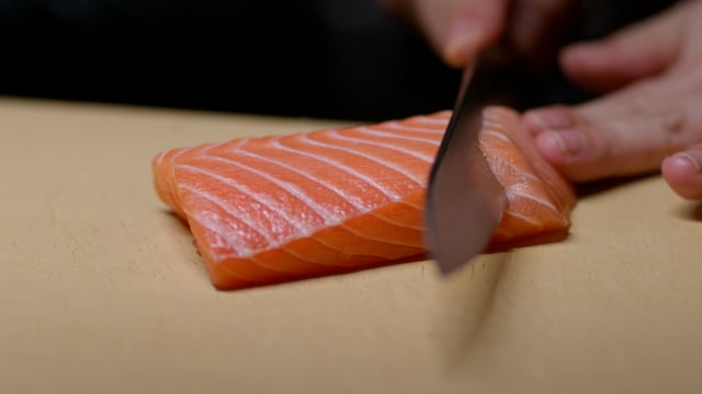 Perfect salmon cut. Creating amazing sushi and sashimi at a high-end sushi restaurant. 