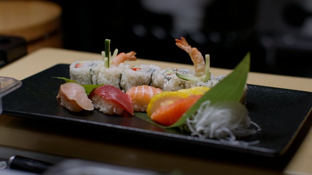 Nigiri hand roll sushi dinner plate. Creating amazing sushi and sashimi at a high-end sushi restaurant. 