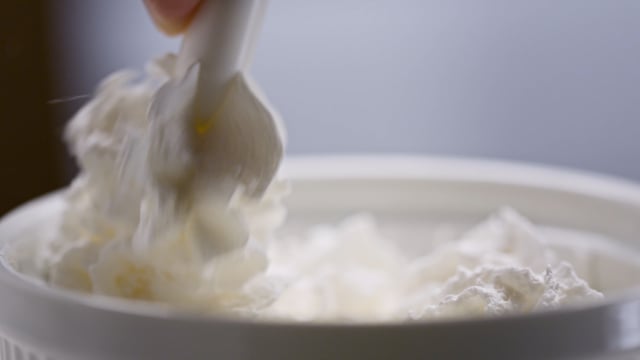 Sweet and fluffy whipped cream fills a bowl as we prepare a decadent dessert. 
