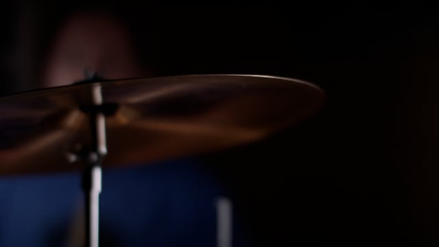 High energy cymbal crash from drummer during musical performance. 