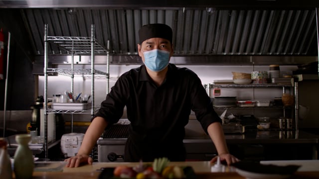 Japanese Chef and small business owner wearing a mask. Professional sushi chef portrait.