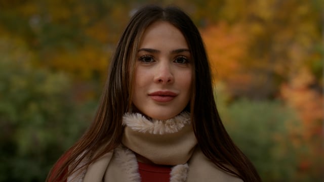 Portrait of a beautiful young professional woman cast against the rich colours of nature in autumn.