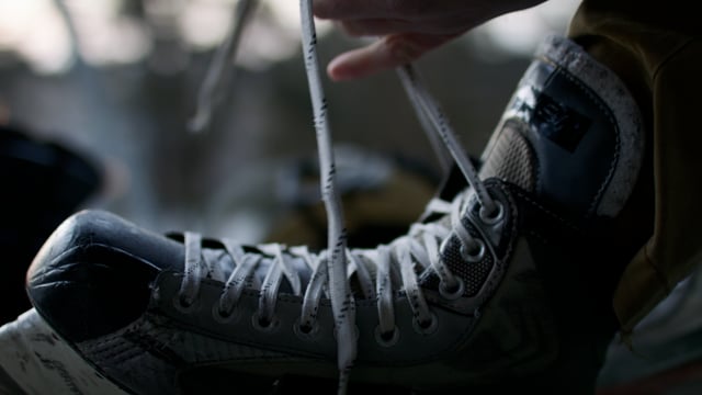 Lacing up skates for a winter skate outdoors. 