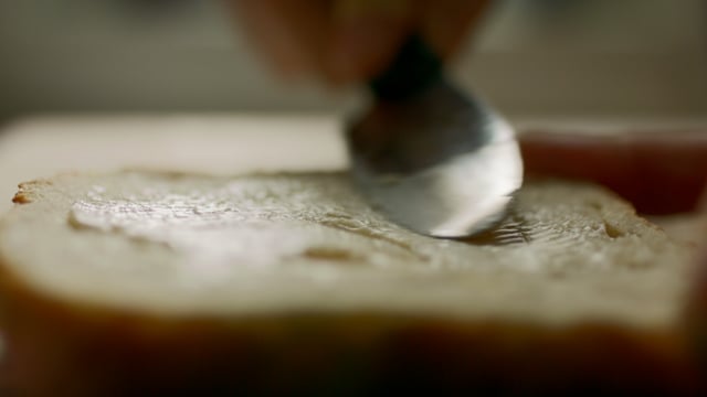 Butter spread on a slice of fresh bread.