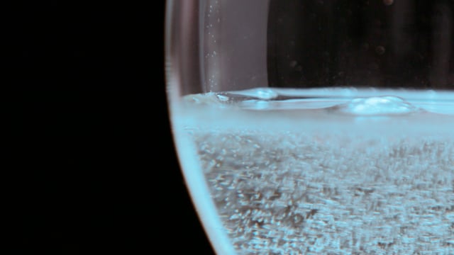 Champagne bubbles and fizzes in slow motion. 