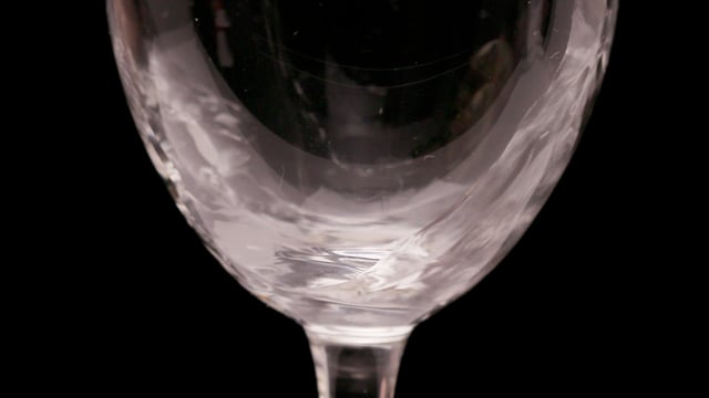 Champagne filling glass at 120fps, macro close-up. 