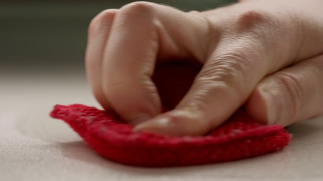 Wiping the surface with a red cloth to remove viruses and bacteria. 