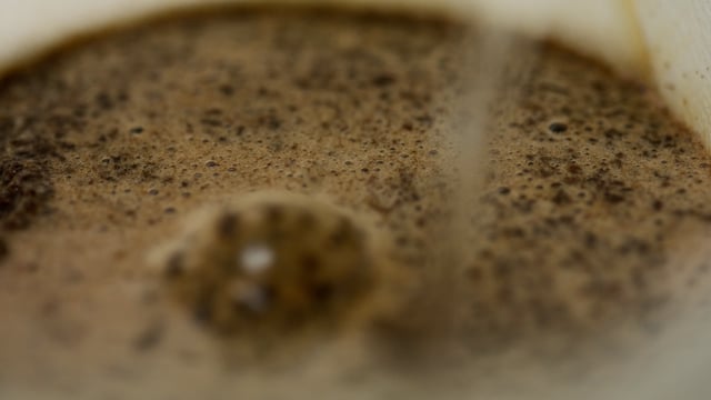 Ground and roasted coffee beans placed into Pour Over coffee maker.