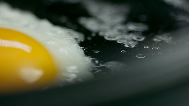Egg on a cast-iron frying pan. Yellow yoke. 
