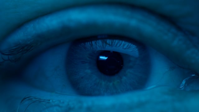 Human eye close-up footage with the iris visible closely. 