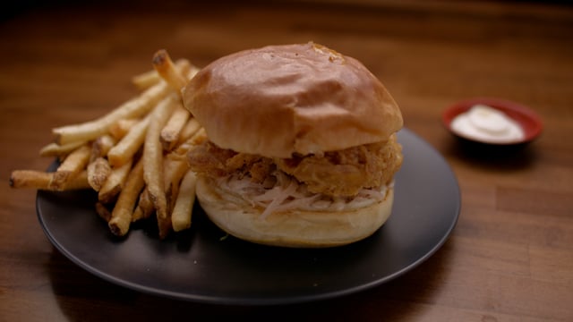 Dinner is served. Delicious fried chicken sandwich and french fries ready to be eaten.