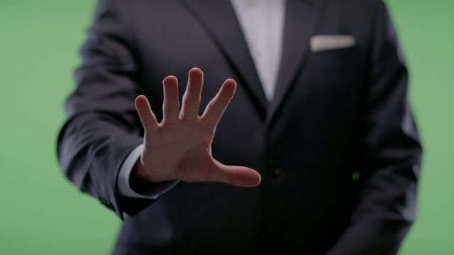 Waving hand in welcoming gesture from Businessman on green screen. 