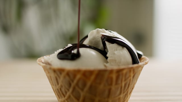 Yummy ice cream in a waffle cone. Closeup footage of delicious dessert. 