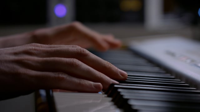 Creative music producer playing on the keyboard. Gig worker making music in the studio. Piano keyboard, music instrument.