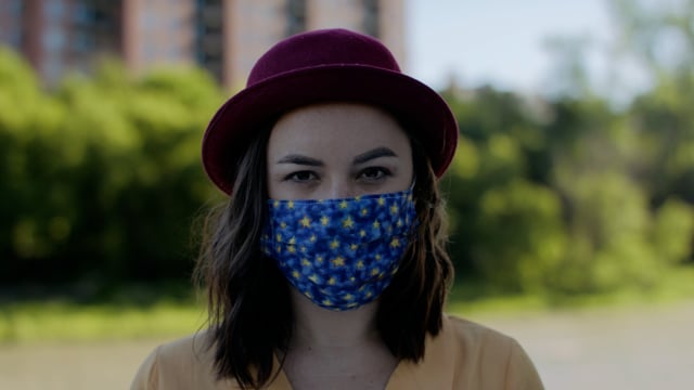 Portrait of a young modern woman wearing a stylish face mask. Medical mask protection for pandemic virus. 