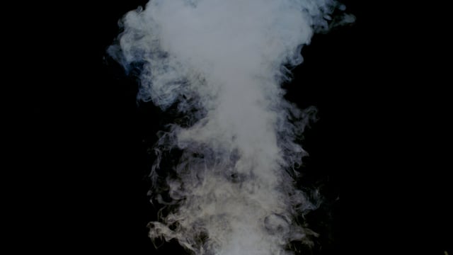 Puff of white smoke rising on a black background. Element for VFX shot.