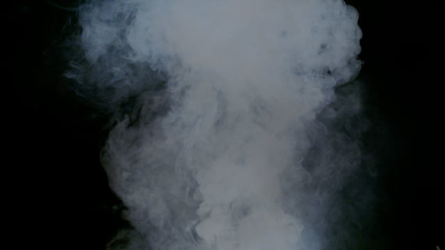 Swirling steam on a black background. Fog and evaporation. Element for a VFX shot. 