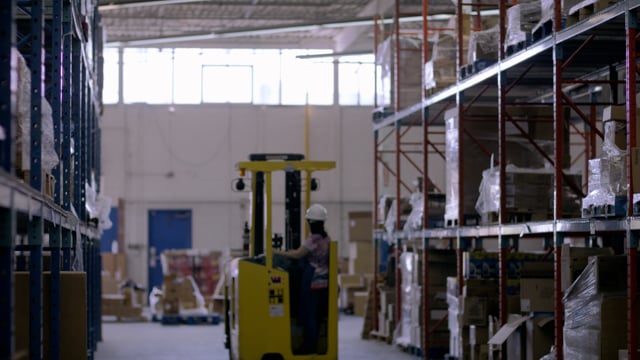 Forklift moves goods in ecommerce warehouse. Ready for shipping to online customers. 
