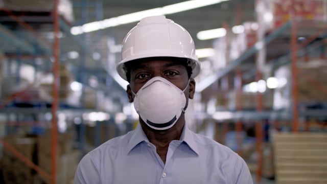 Portrait of a frontline essential worker in a warehouse.