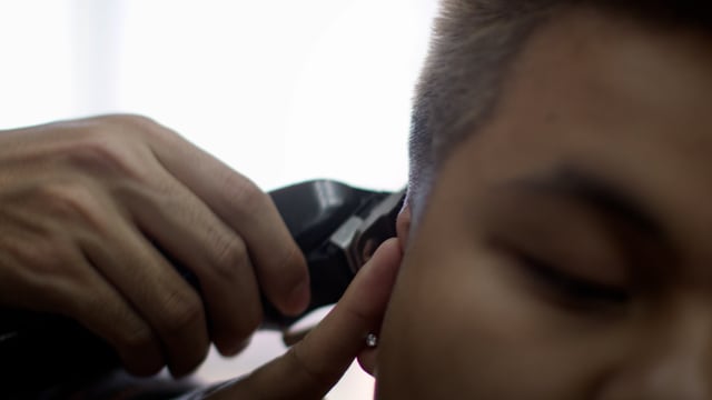 Barber shop haircut. A man gets a new clean look at a hip barber shop.